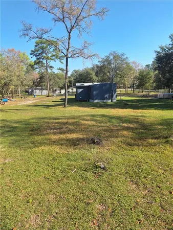 a view of a large pool with a yard