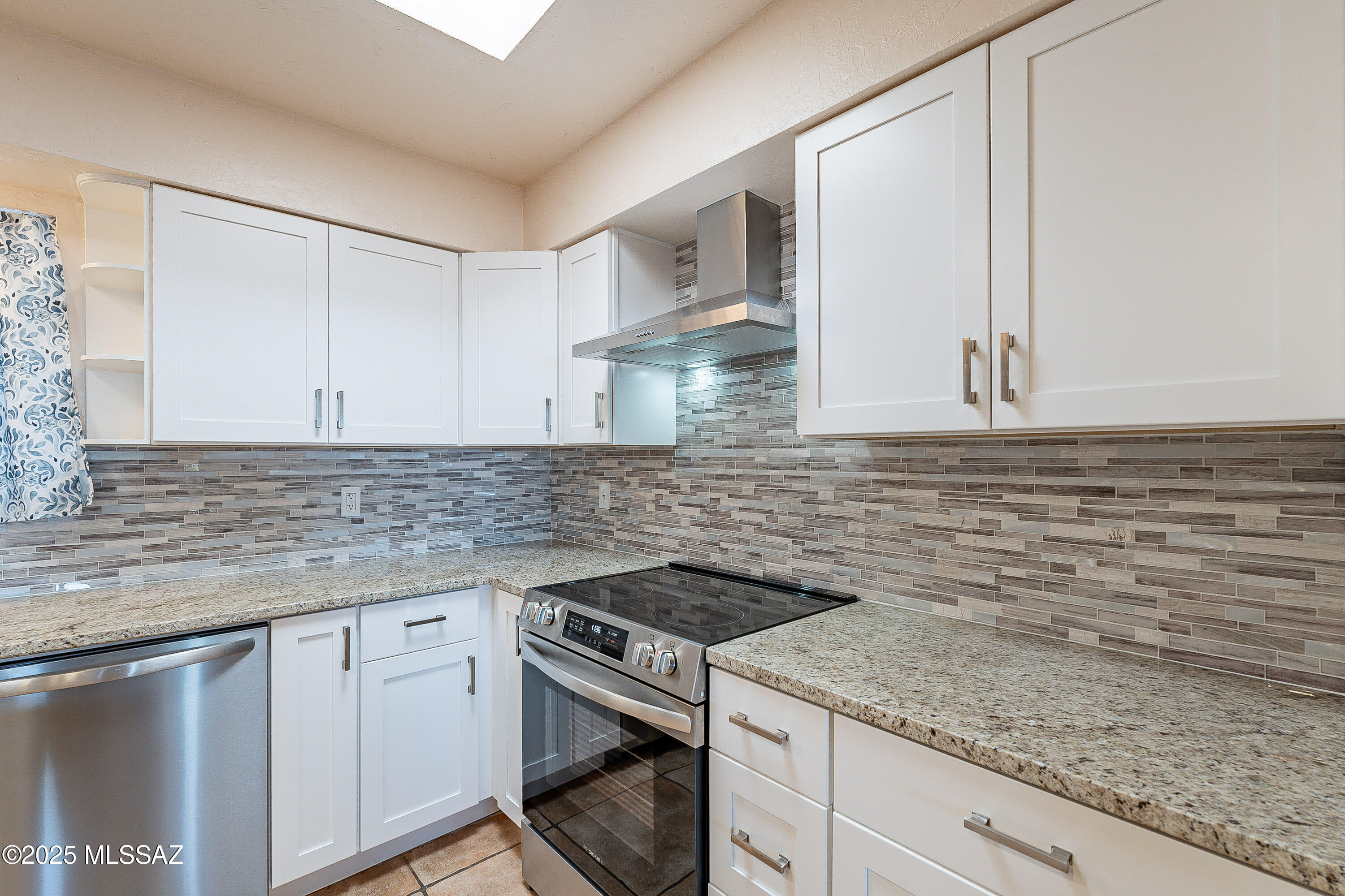 467 Camino Osito Rio Rico, AZ 85648 - Photo 12 of 50 a kitchen with stainless steel appliances granite countertop a sink stove and cabinets