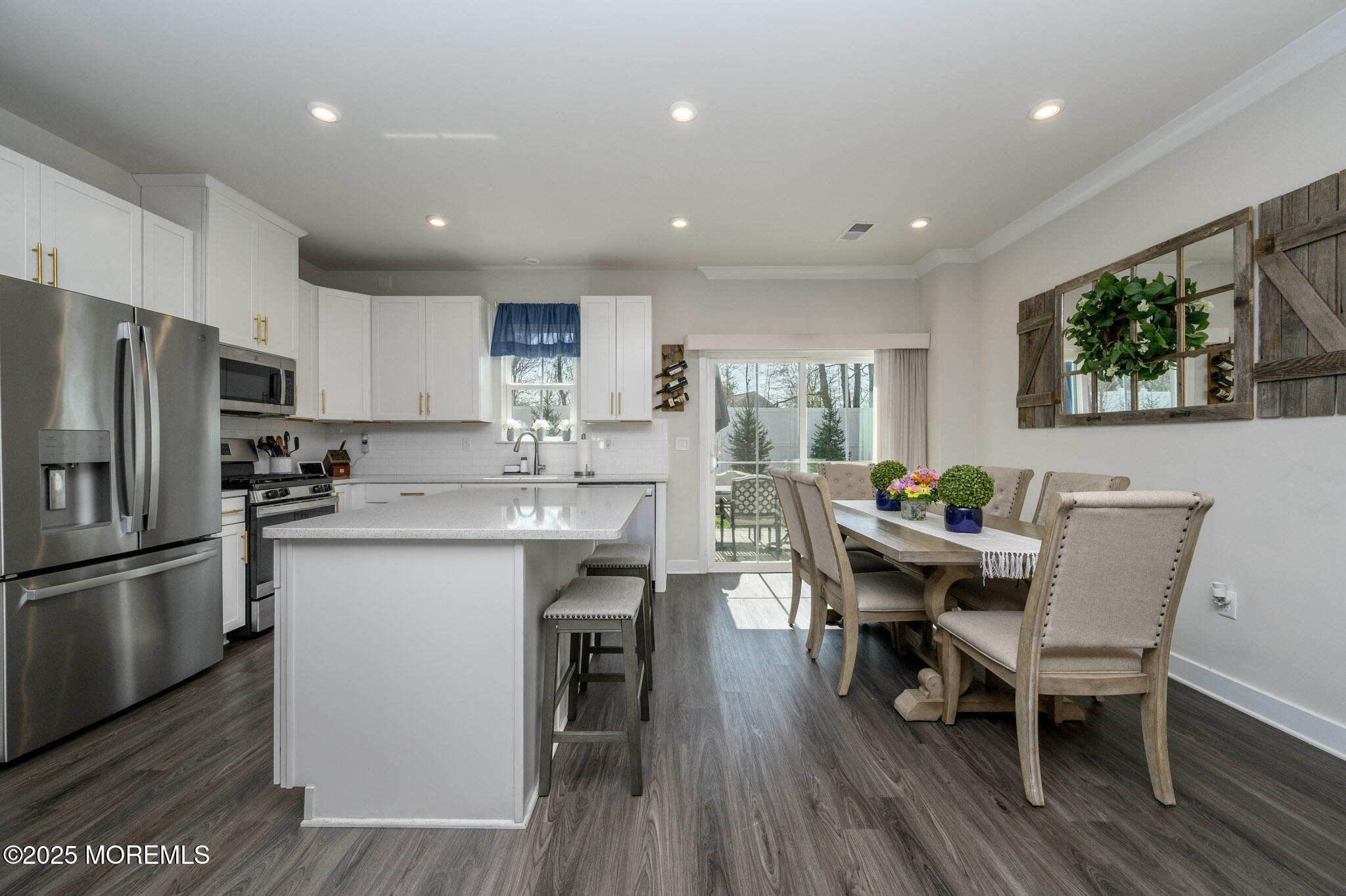 48 Athens Way Cliffwood, NJ 07721 - Photo 8 of 39 a kitchen with stainless steel appliances granite countertop a dining table chairs refrigerator sink and cabinets