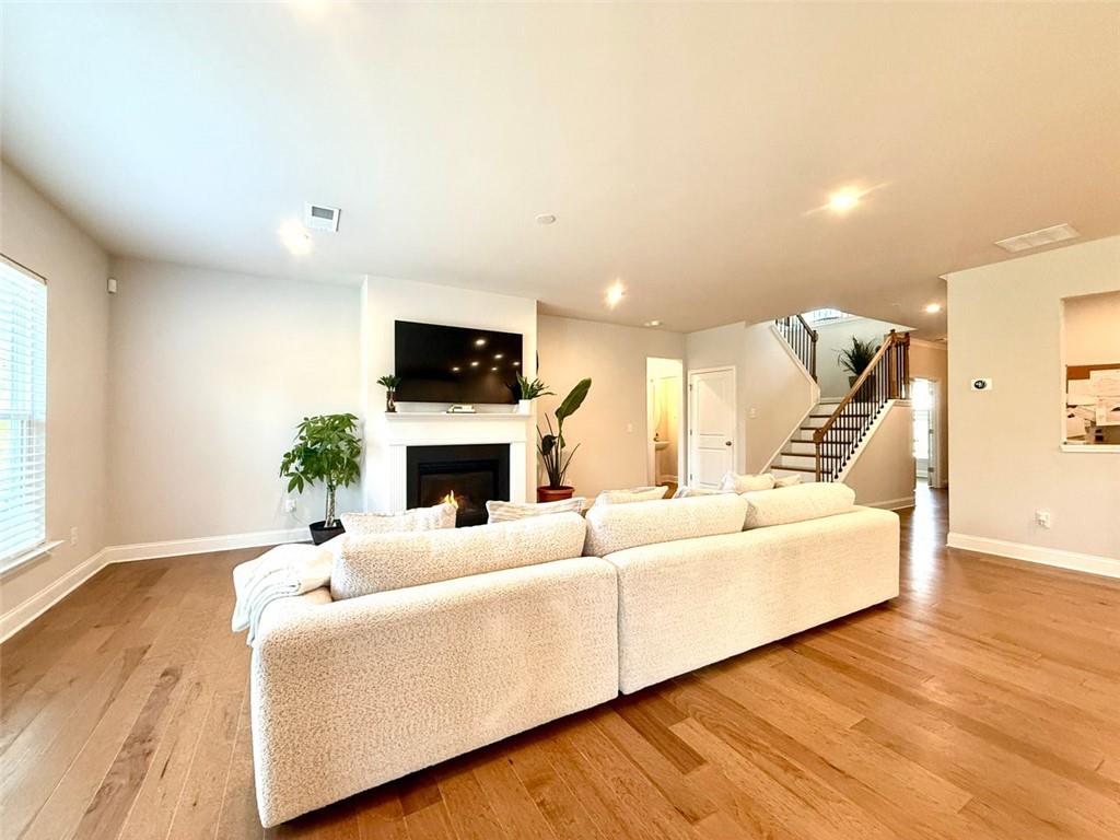 26 Riverclub Road Acworth, GA 30101 - Photo 20 of 73 a living room with furniture a fireplace and a flat screen tv