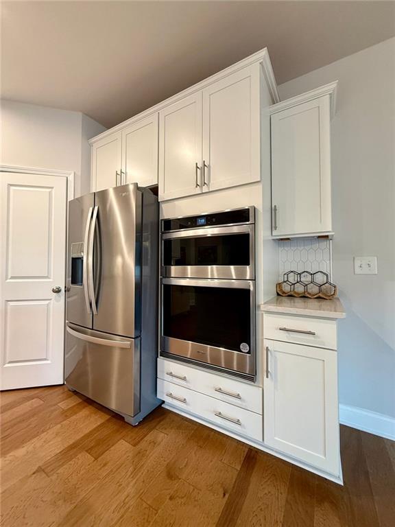 26 Riverclub Road Acworth, GA 30101 - Photo 30 of 73 a kitchen with granite countertop white cabinets and stainless steel appliances
