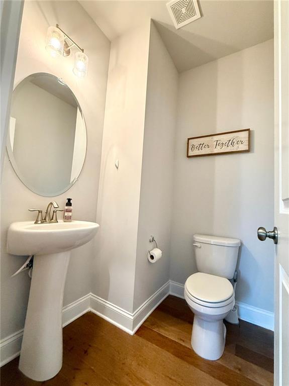 26 Riverclub Road Acworth, GA 30101 - Photo 41 of 73 a bathroom with a toilet sink and mirror