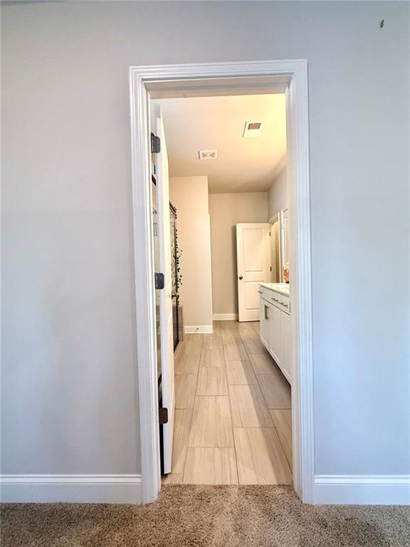 26 Riverclub Road Acworth, GA 30101 - Photo 46 of 73 a view of a hallway with a white cabinet and a large mirror