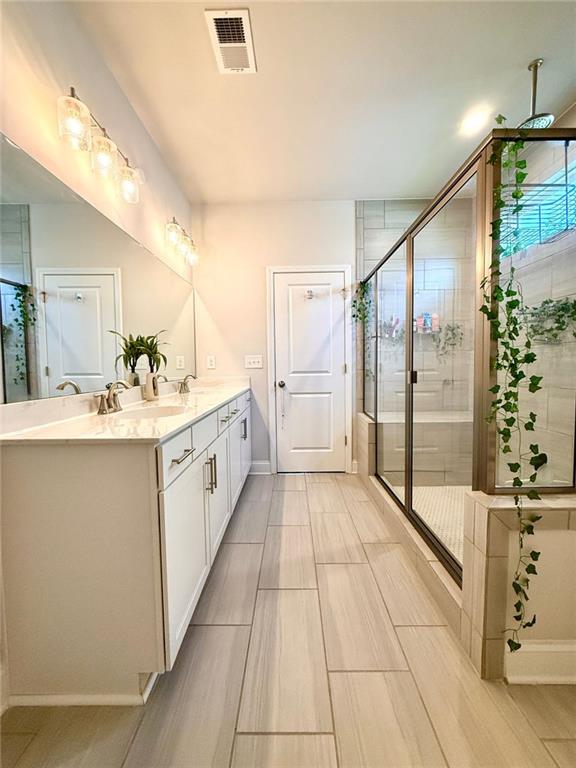 26 Riverclub Road Acworth, GA 30101 - Photo 50 of 73 a bathroom with a double vanity sink and mirror