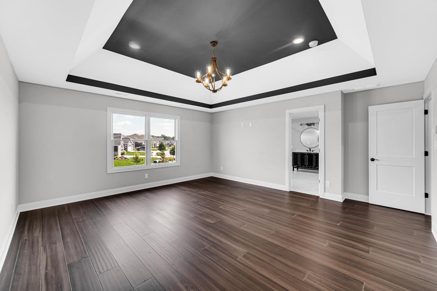 11039 Macedon Street Winfield, IN 46307 - Photo 18 of 36 a view of an empty room wooden floor and a ceiling fan