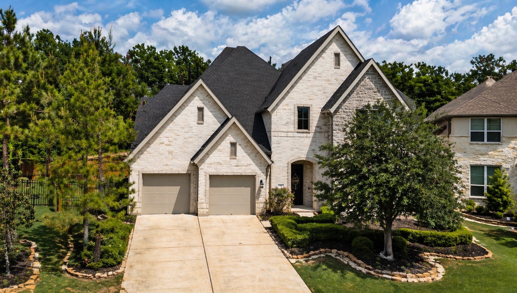 26910 Selinsgrove Road Magnolia, TX 77354 - Photo 14 of 50 Elevated drone perspective showcases the grand roof lines and beautiful architectural symmetry of the home.