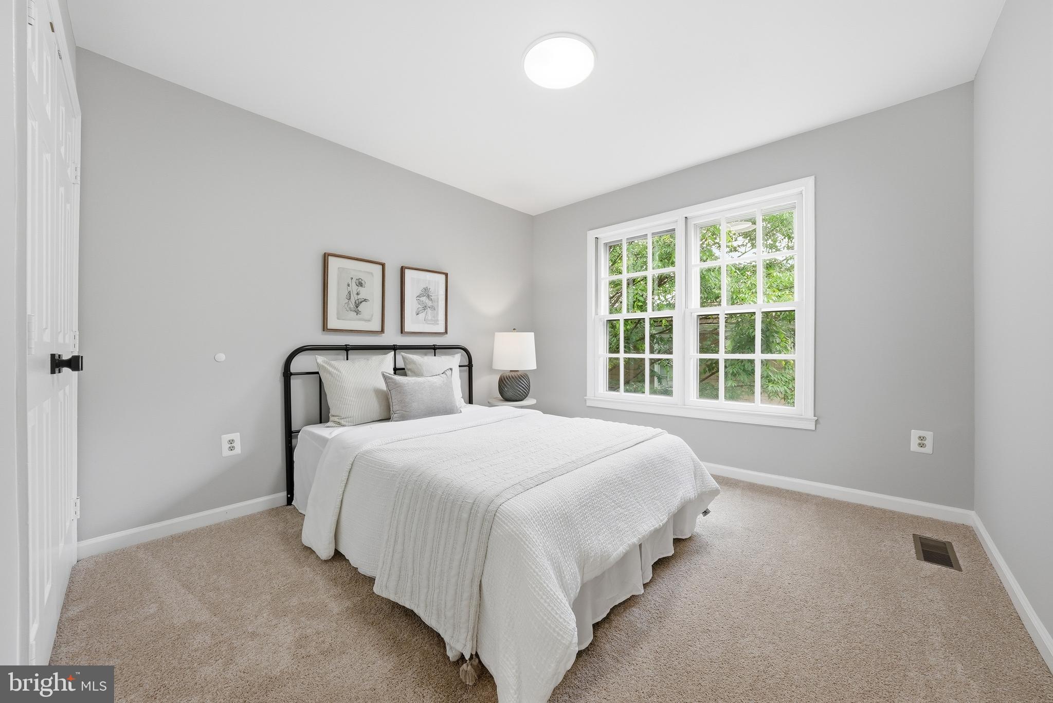 1291 Lamplighter Way Reston, VA 20194 - Photo 46 of 60 a large bed sitting in a bedroom next to a window and a dresser