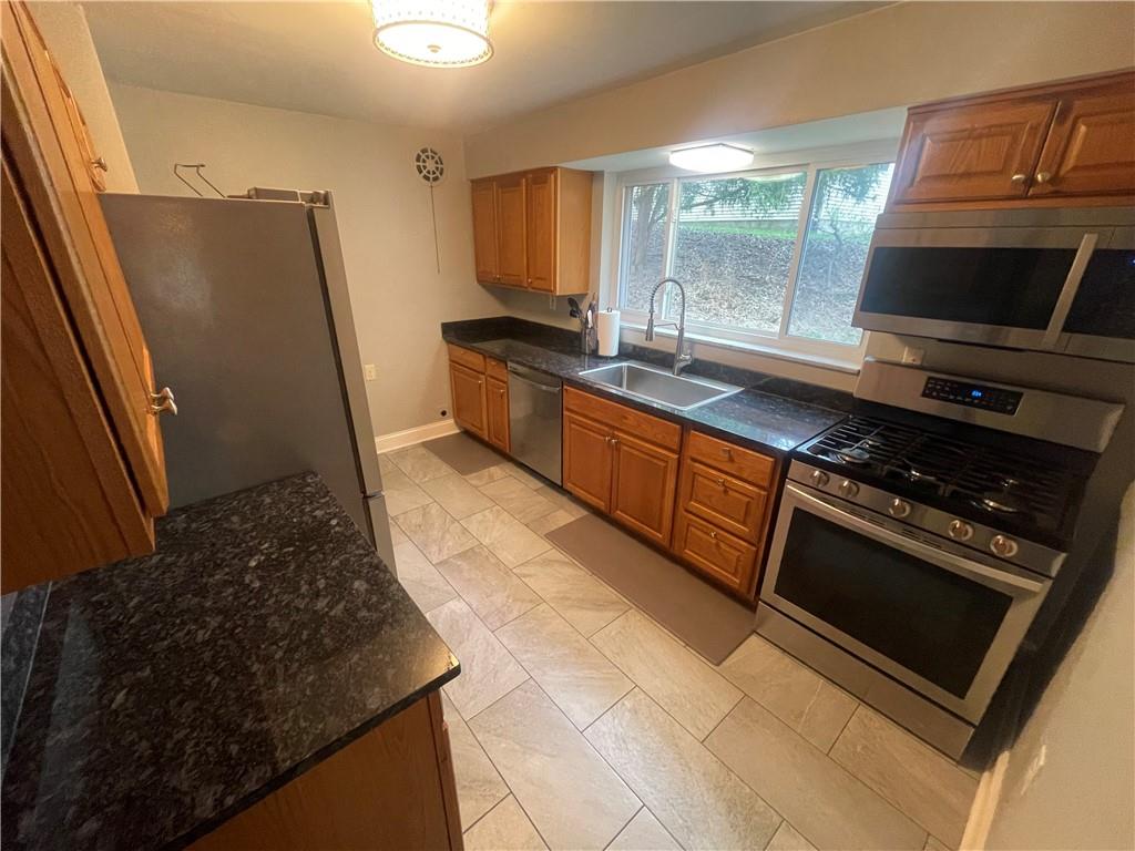 1815 Sample Road Allison Park, PA 15101 - Photo 17 of 40 a kitchen with stainless steel appliances granite countertop a stove a sink and a refrigerator