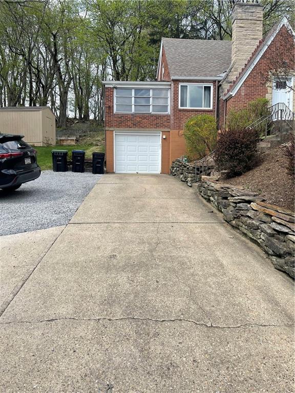 1815 Sample Road Allison Park, PA 15101 - Photo 3 of 40 a front view of a house with a yard and garage