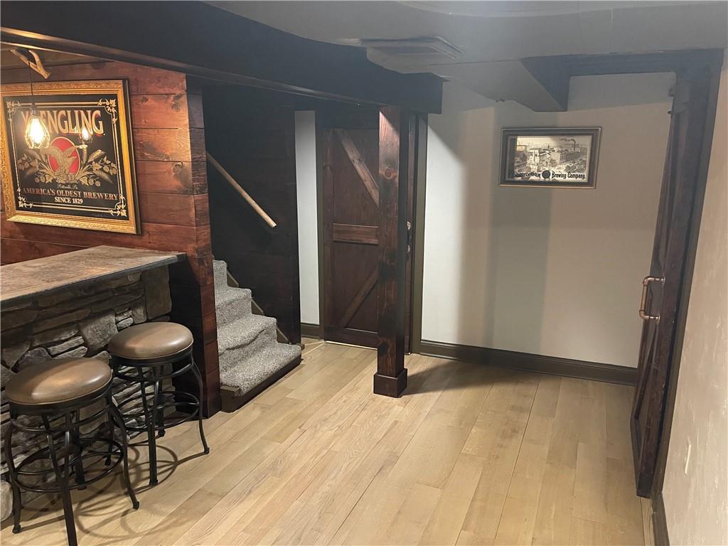 1815 Sample Road Allison Park, PA 15101 - Photo 32 of 40 a view of a hallway with wooden floor and furniture