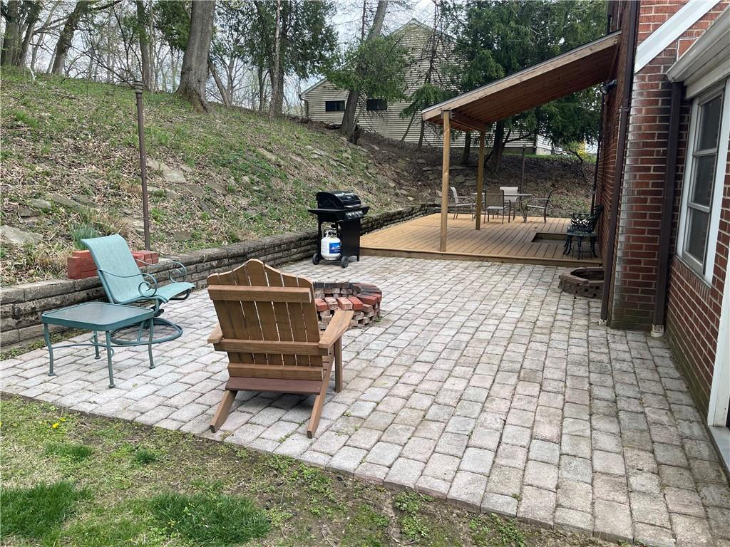 1815 Sample Road Allison Park, PA 15101 - Photo 7 of 40 a view of a patio with table and chairs with wooden floor and fence