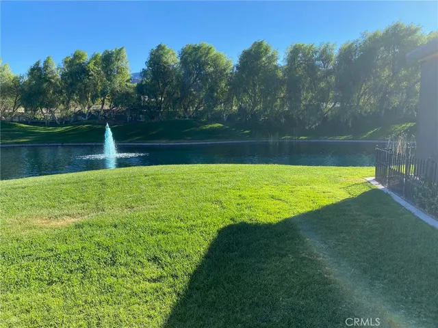 a view of a swimming pool with a yard