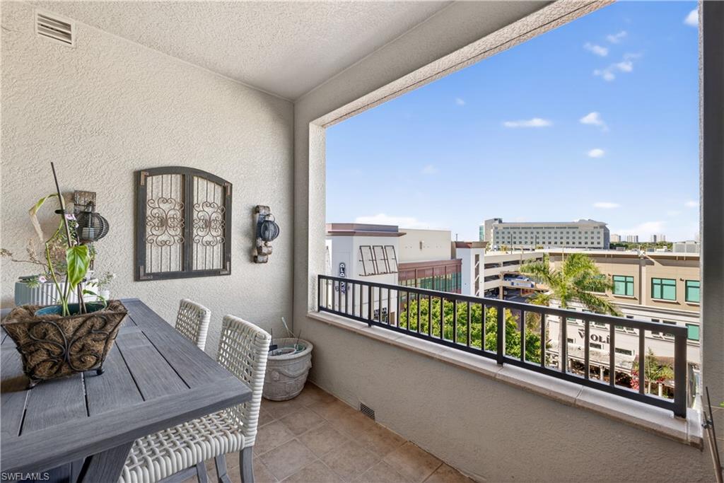 9115 Strada Place, Unit 5504 Naples, FL 34108 - Photo 14 of 22 a view of a balcony with furniture