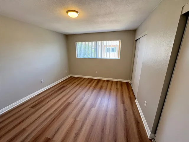 a view of a room with wooden floor and window