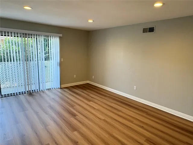 an empty room with wooden floor