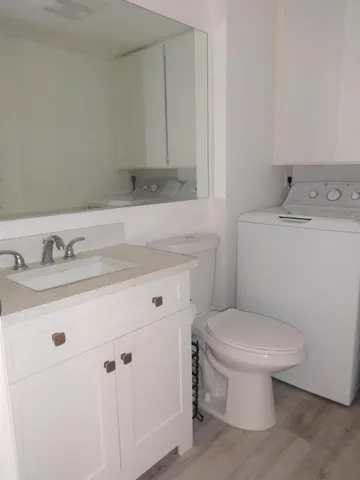 a bathroom with a sink toilet and vanity