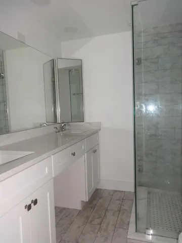 a bathroom with a double vanity sink and a mirror