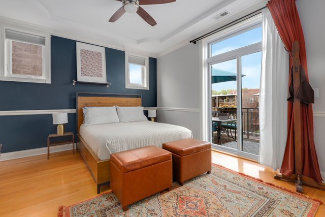 4730 North Malden Street, Unit 3 Chicago, IL 60640 - Photo 11 of 25 a bedroom with a bed and a chandelier
