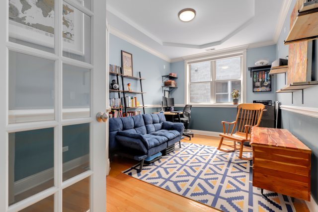 4730 North Malden Street, Unit 3 Chicago, IL 60640 - Photo 18 of 25 a living room with furniture a lamp and a window