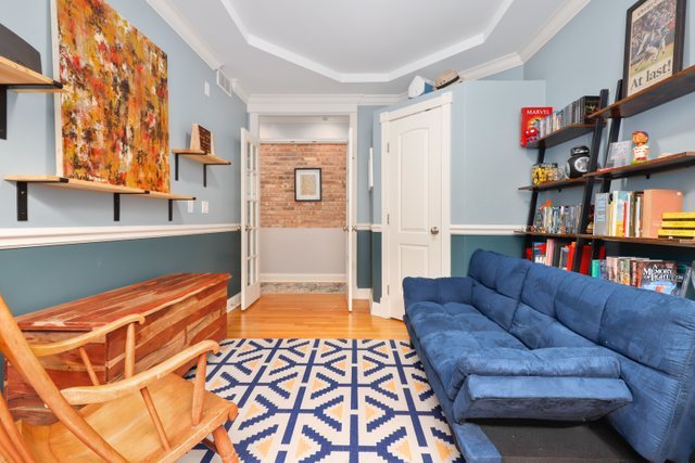 4730 North Malden Street, Unit 3 Chicago, IL 60640 - Photo 19 of 25 a living room with furniture and a book shelf