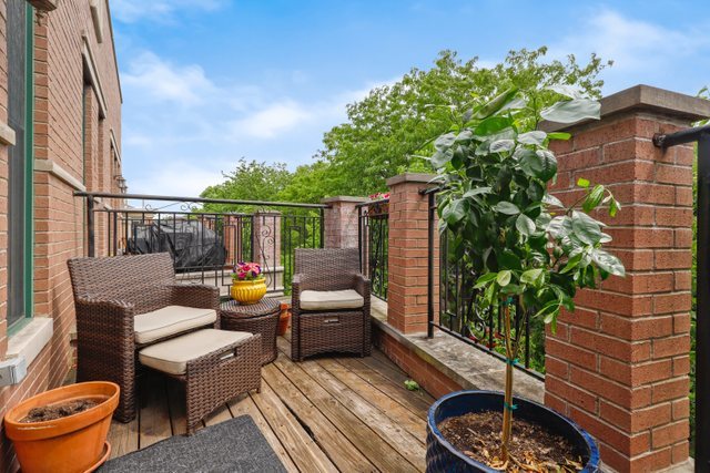 4730 North Malden Street, Unit 3 Chicago, IL 60640 - Photo 23 of 25 a backyard of a house with barbeque oven table and chairs