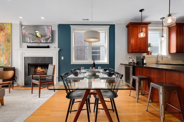 4730 North Malden Street, Unit 3 Chicago, IL 60640 - Photo 6 of 25 a view of a dining room with furniture and a fireplace