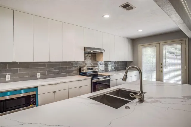 a kitchen that has a sink and a stove