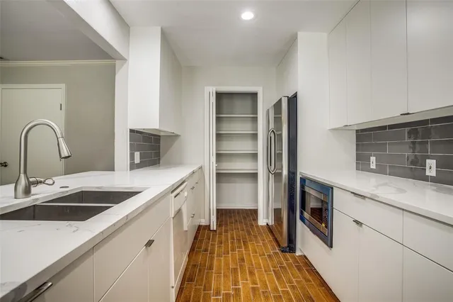 a kitchen with a sink and a refrigerator