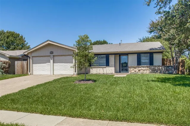 a front view of a house with a yard and porch