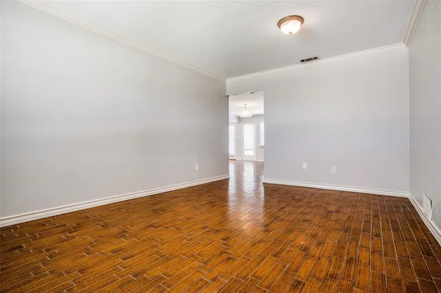a view of an empty room and wooden floor