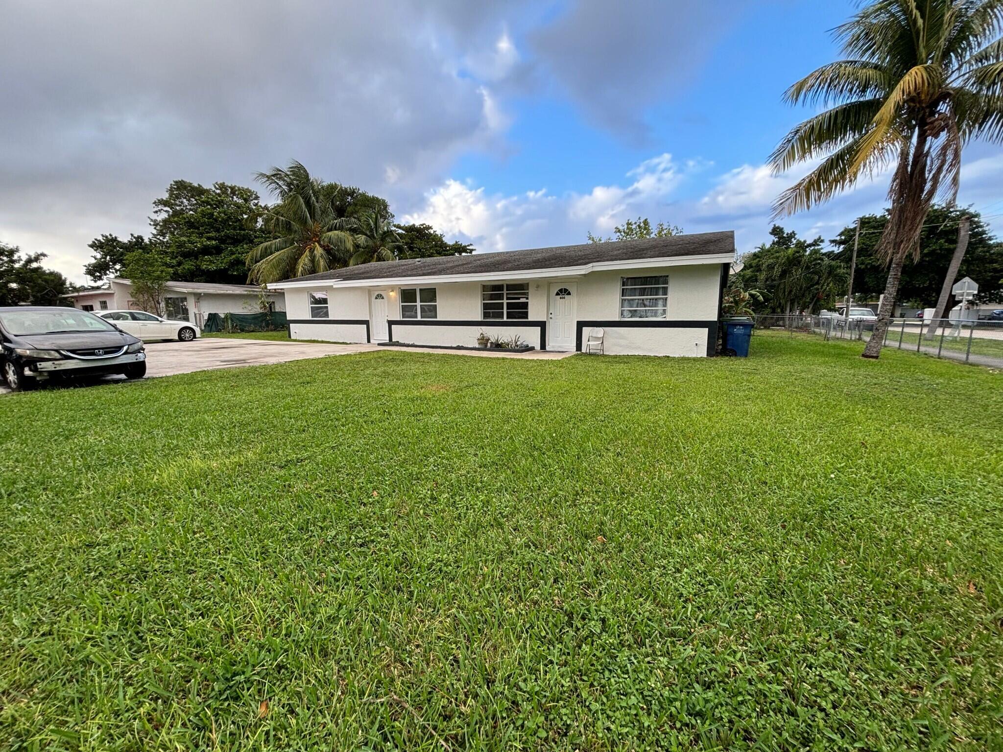 800 Southwest 7th Street Hallandale Beach, FL 33009 - Photo 1 of 9 a front view of a house with garden