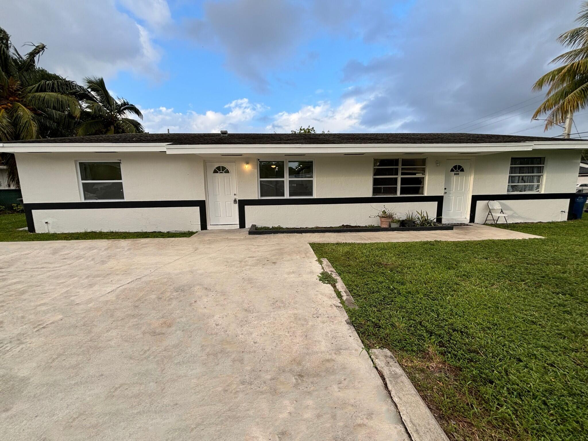 800 Southwest 7th Street Hallandale Beach, FL 33009 - Photo 2 of 9 a front view of house with yard and seating area