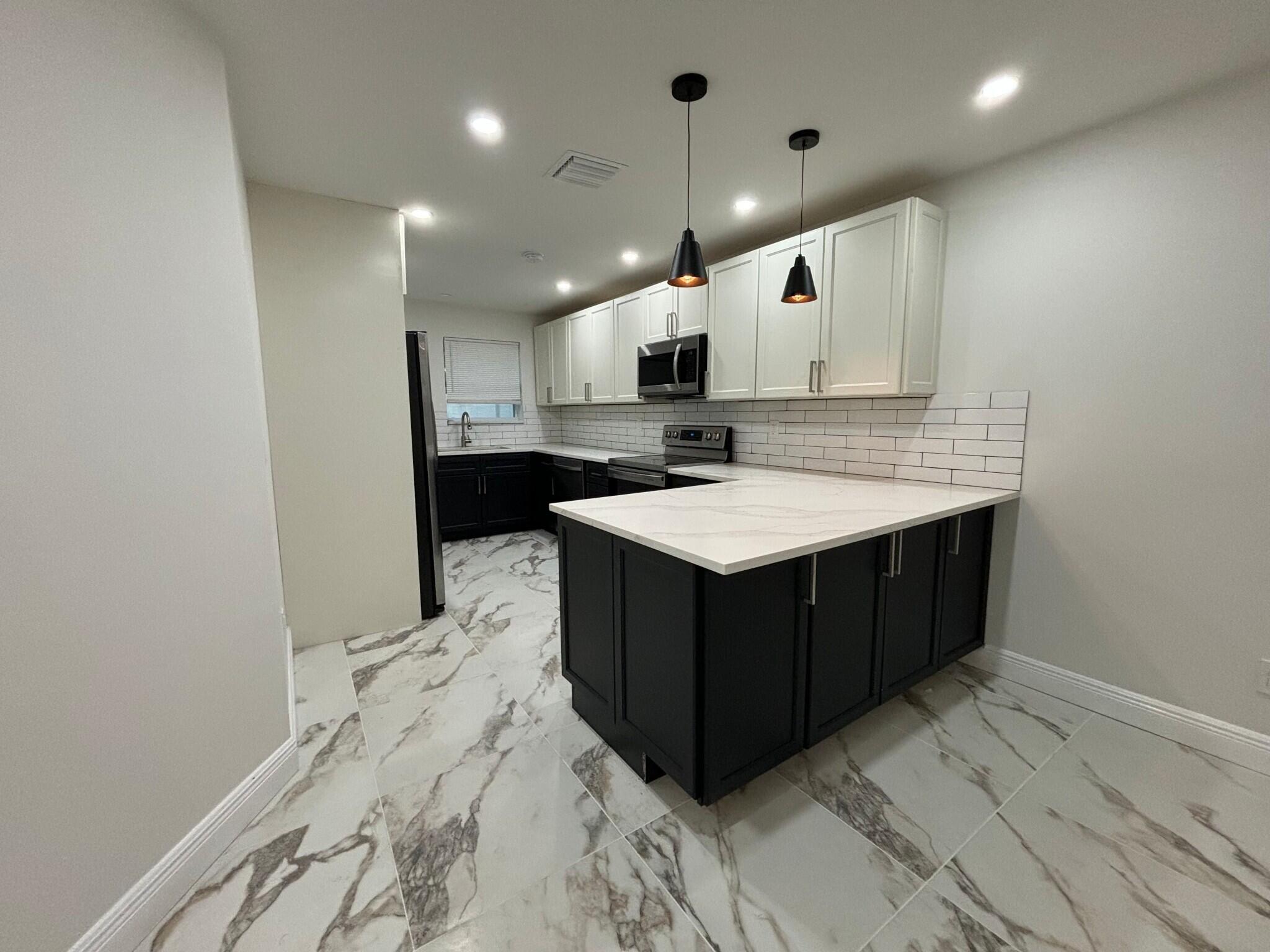 800 Southwest 7th Street Hallandale Beach, FL 33009 - Photo 5 of 9 a kitchen with a sink and cabinets