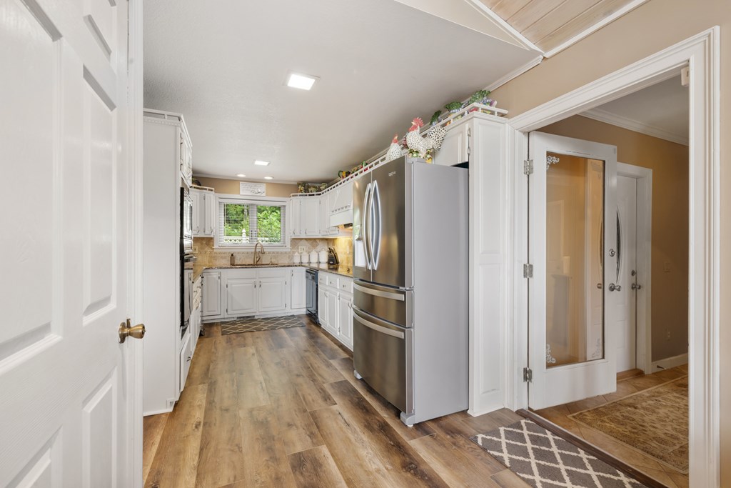 1396 Deerfield Road Young Harris, GA 30582 - Photo 13 of 60 a kitchen with a refrigerator and white cabinets