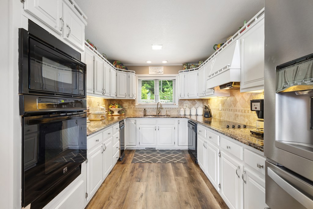 1396 Deerfield Road Young Harris, GA 30582 - Photo 14 of 60 a kitchen with stainless steel appliances granite countertop a stove sink and cabinets