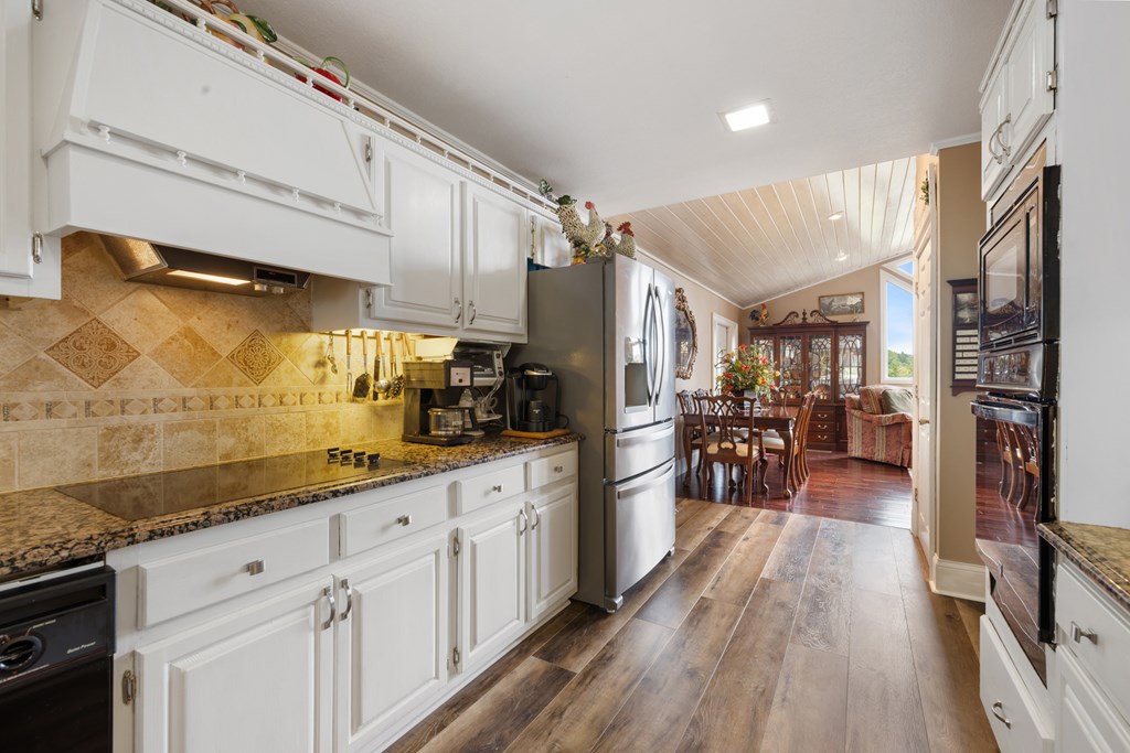 1396 Deerfield Road Young Harris, GA 30582 - Photo 15 of 60 a kitchen with cabinets and wooden floor