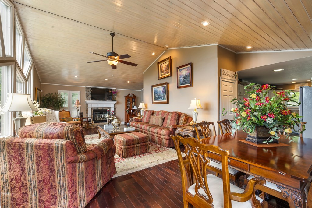 1396 Deerfield Road Young Harris, GA 30582 - Photo 18 of 60 a living room with furniture a flowers and a fireplace
