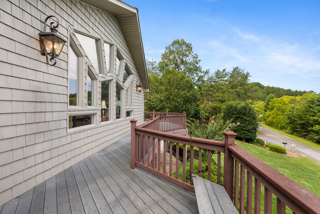 1396 Deerfield Road Young Harris, GA 30582 - Photo 26 of 60 a view of balcony with wooden floor and fence