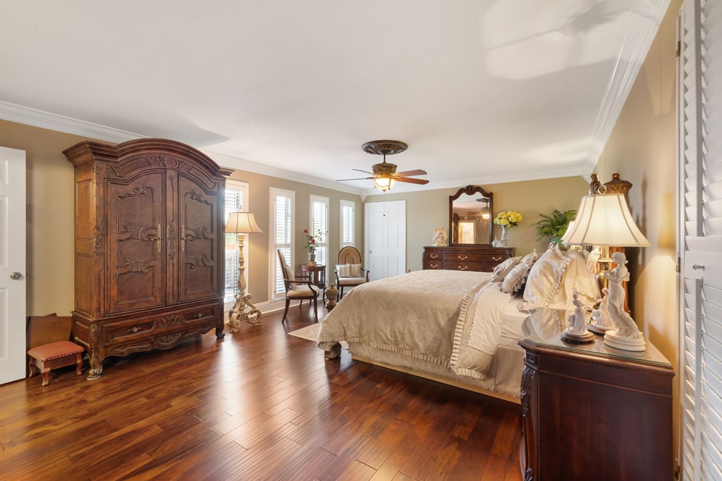 1396 Deerfield Road Young Harris, GA 30582 - Photo 32 of 60 a spacious bedroom with a bed a table and wooden floor