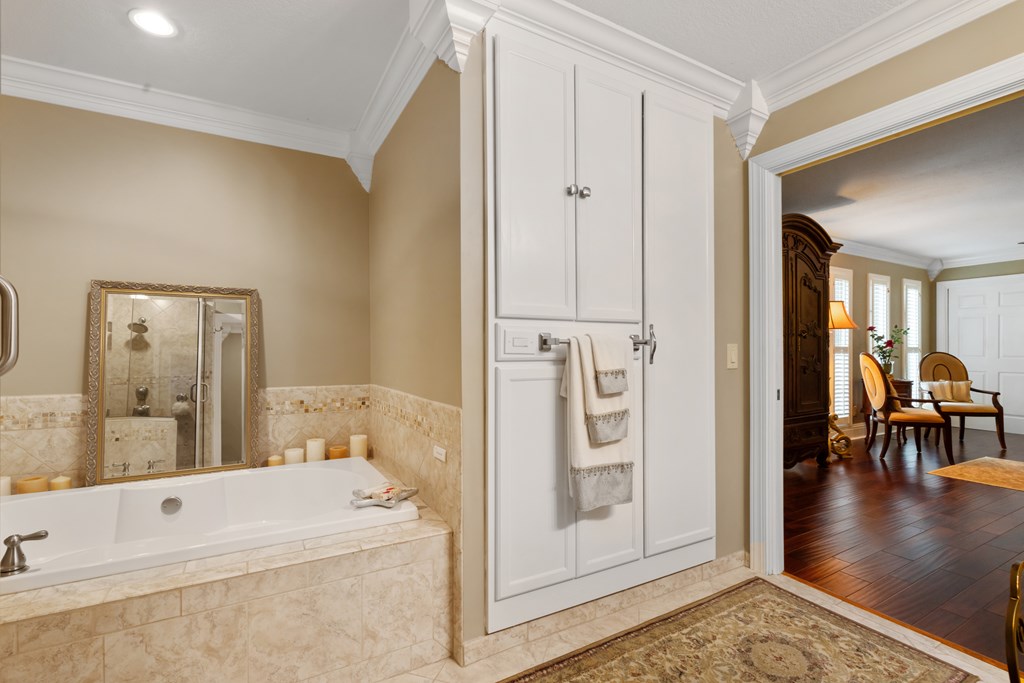 1396 Deerfield Road Young Harris, GA 30582 - Photo 37 of 60 a spacious bathroom with a tub a mirror and a sink