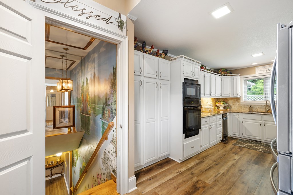 1396 Deerfield Road Young Harris, GA 30582 - Photo 41 of 60 a kitchen with cabinets and wooden floor