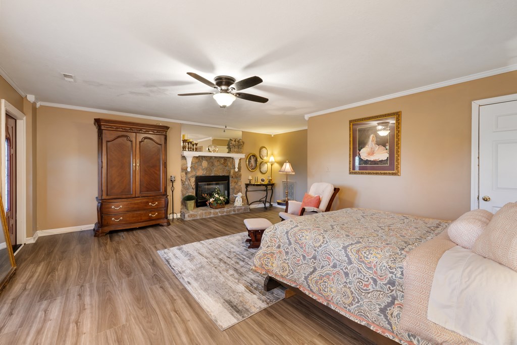 1396 Deerfield Road Young Harris, GA 30582 - Photo 48 of 60 a bedroom with a large bed a flat tv screen and dresser