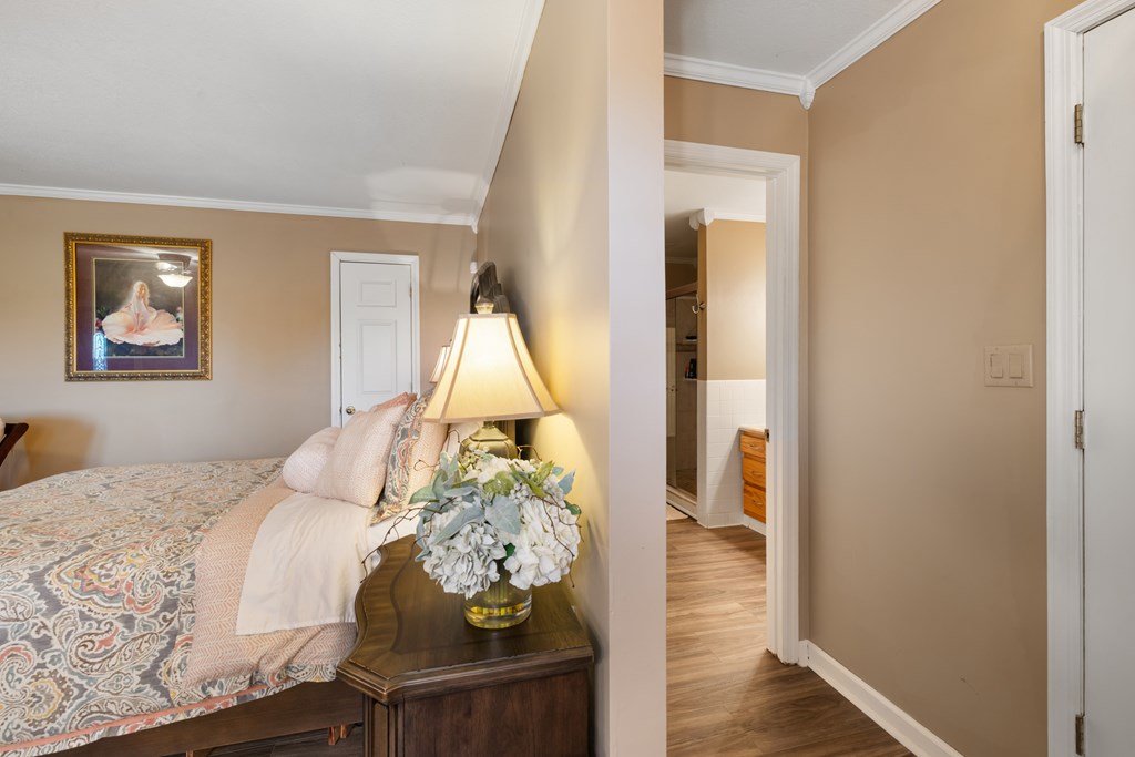 1396 Deerfield Road Young Harris, GA 30582 - Photo 49 of 60 a bedroom with a bed and a wooden floor