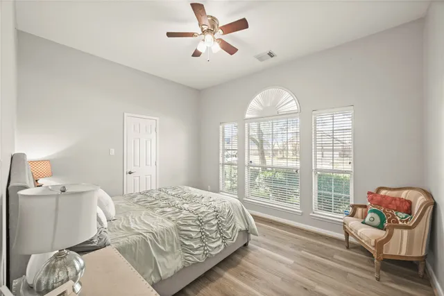 a bedroom with a bed and a large window