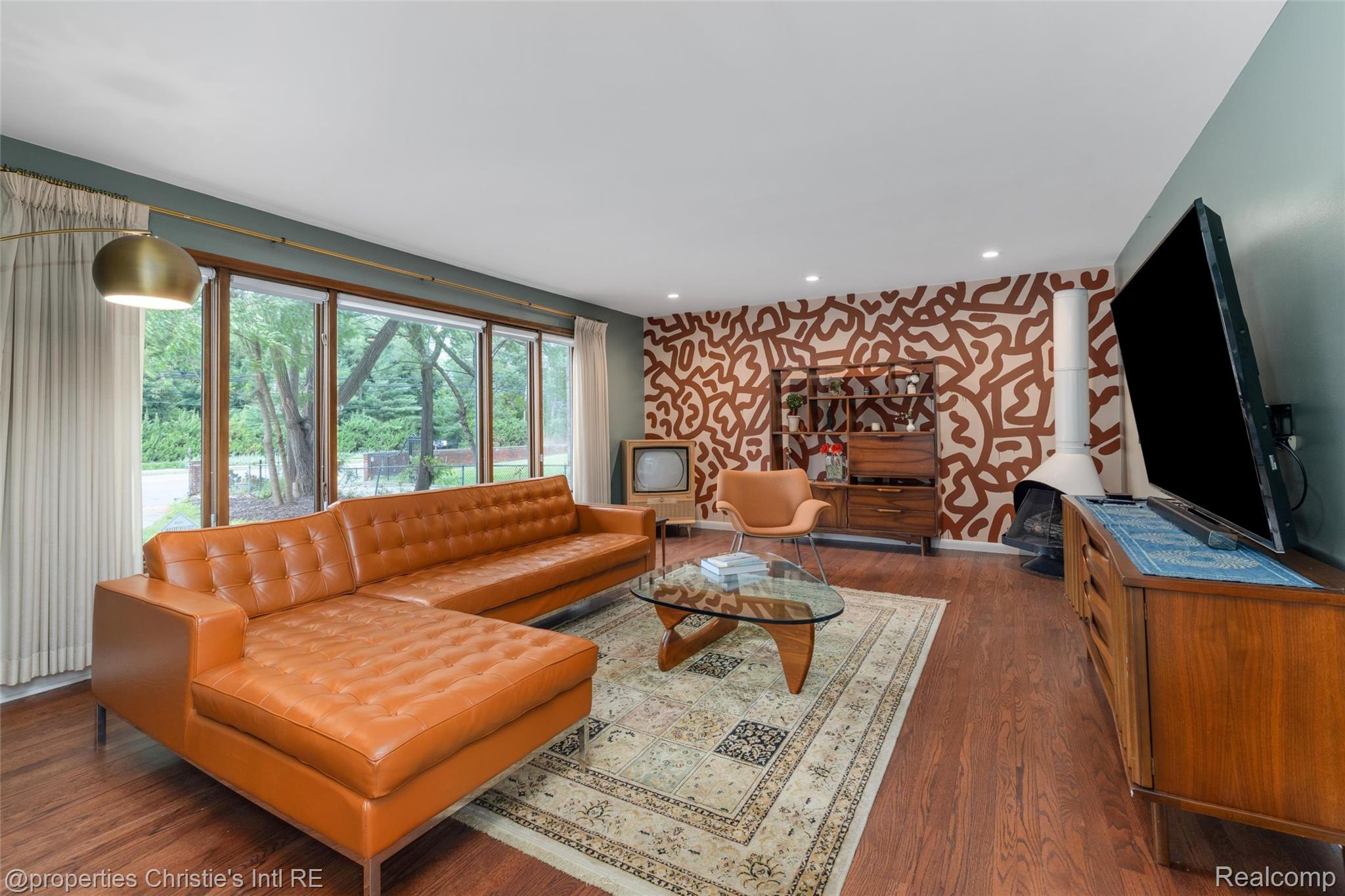 2771 West Seven Mile Road Detroit, MI 48221 - Photo 21 of 57 Living area featuring wood-finish flooring, a full wall of floor-to-ceiling windows, and recessed ceiling lighting