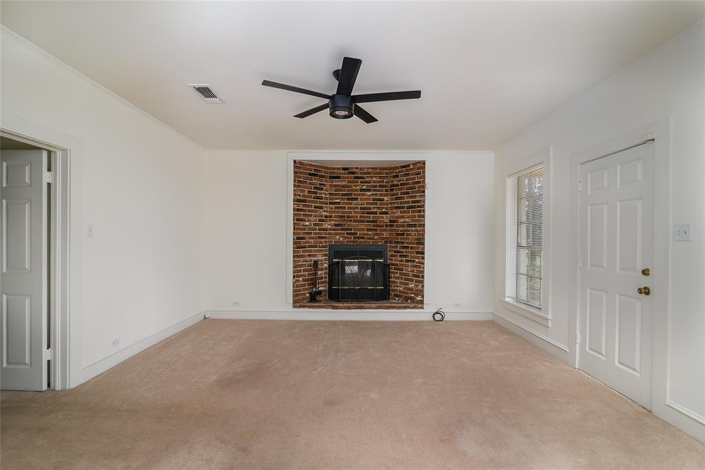 13040 Adger Road Gilliam, LA 71029 - Photo 4 of 29 a view of an empty room with a fireplace and a window