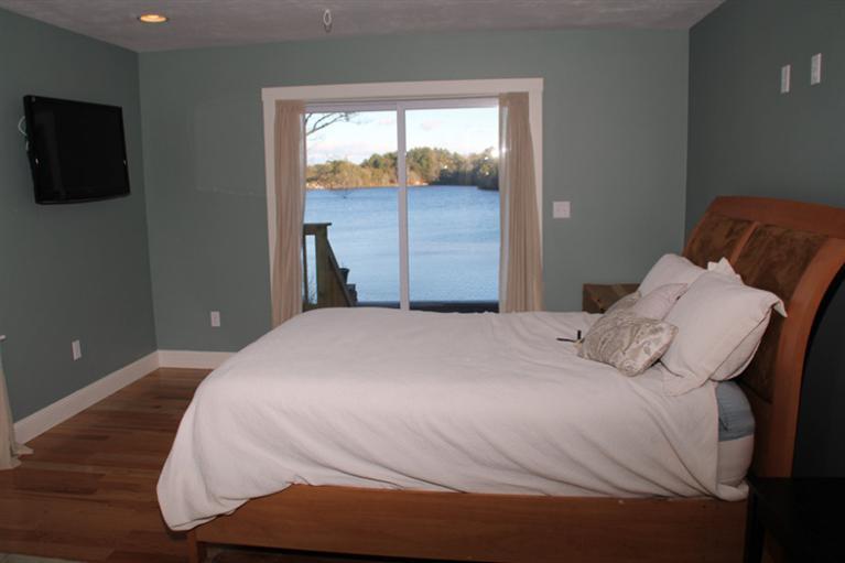 173 Sandy Beach Road Plymouth, MA 02360 - Photo 16 of 35 a bedroom with a bed and a flat screen tv