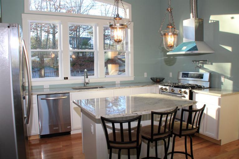 173 Sandy Beach Road Plymouth, MA 02360 - Photo 6 of 35 a kitchen with stainless steel appliances granite countertop a dining table chairs and a refrigerator