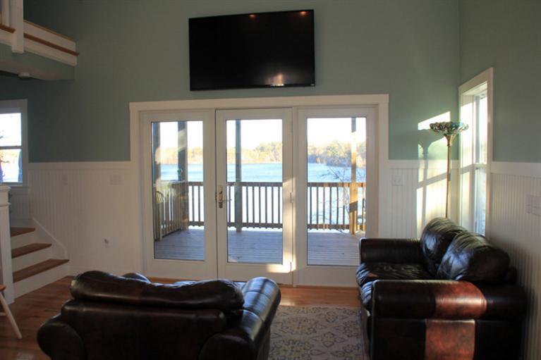 173 Sandy Beach Road Plymouth, MA 02360 - Photo 10 of 35 a living room with furniture and a flat screen tv
