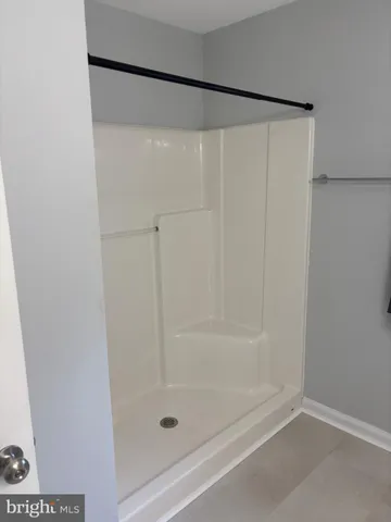 a bathroom with a shower and a bath tub